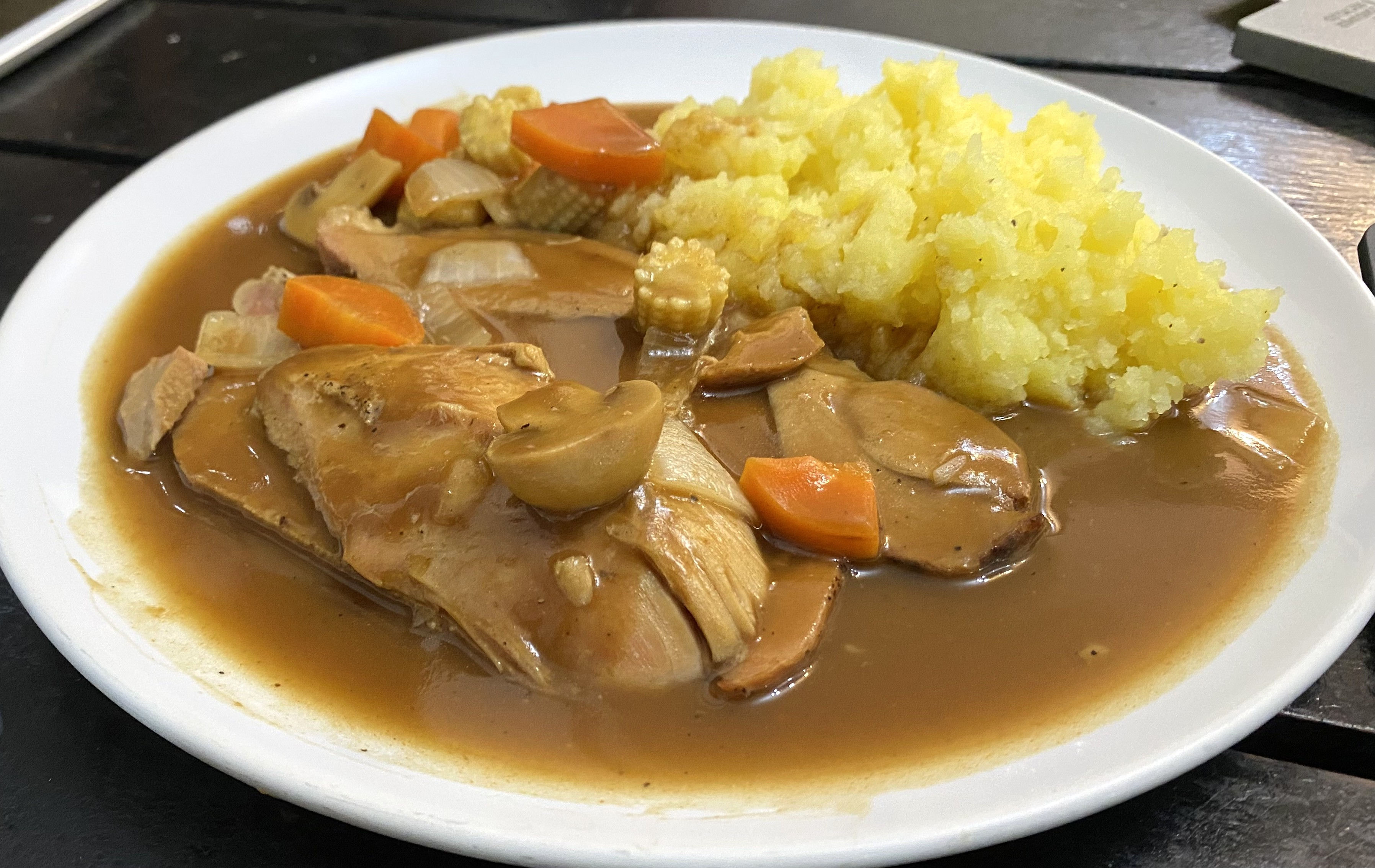 Braised pork and vegetables with mashed potatoes. A tasty ready meal for a quick bite