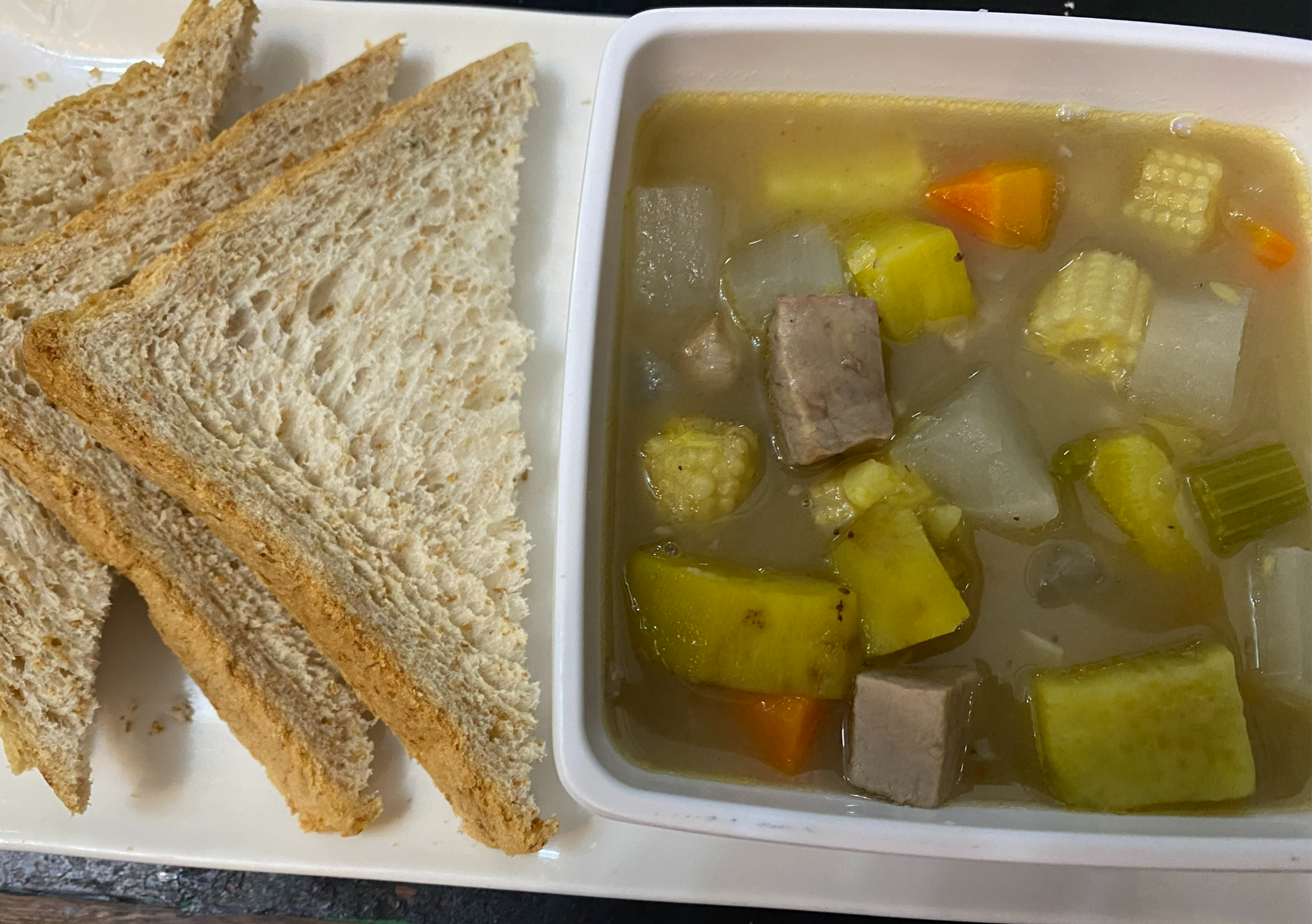 Pork and sweet potato soup served with whole wheat toast.