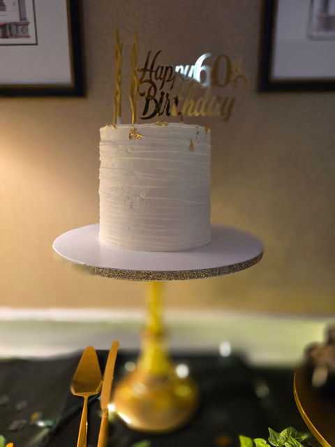 White cake with Happy 60th Birthday sign, Cakes, standing on surface.