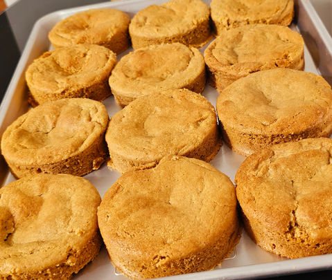 Freshly baked round cookies on a baking sheet