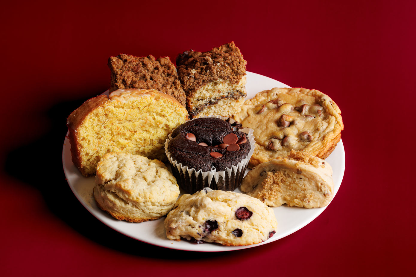 Plate of assorted baked goods including muffins and cookies Enaya's Bakery