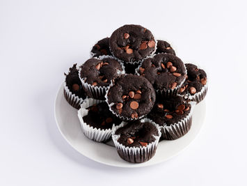 Chocolate chip muffins on white plate. Fresh baked goods from Enaya's Bakery.