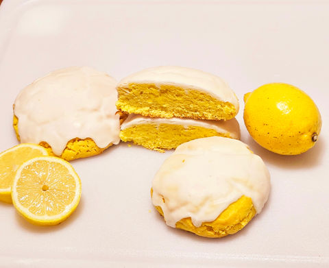 Lemon cookies with white frosting and fresh lemons