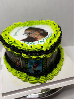 Birthday cake with a bird image and text, decorated with green frosting.