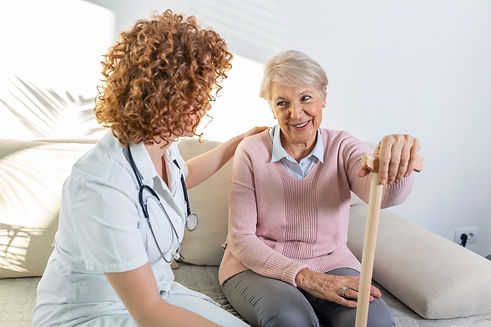 friendly-relationship-smiling-caregiver-uniform-happy-elderly-woman-supportive-young-nurse