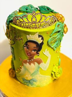 Princess Tiana cake with crown, flowers, and The Mixing Belle on display.