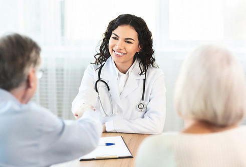 A female Doctor with two Hispanic people