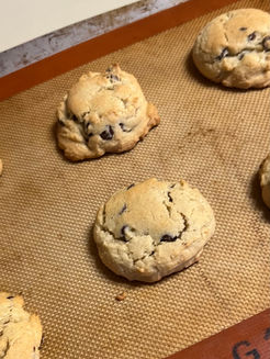 Close up of chocolate chip cookies on a baking sheet. Divine Dough.