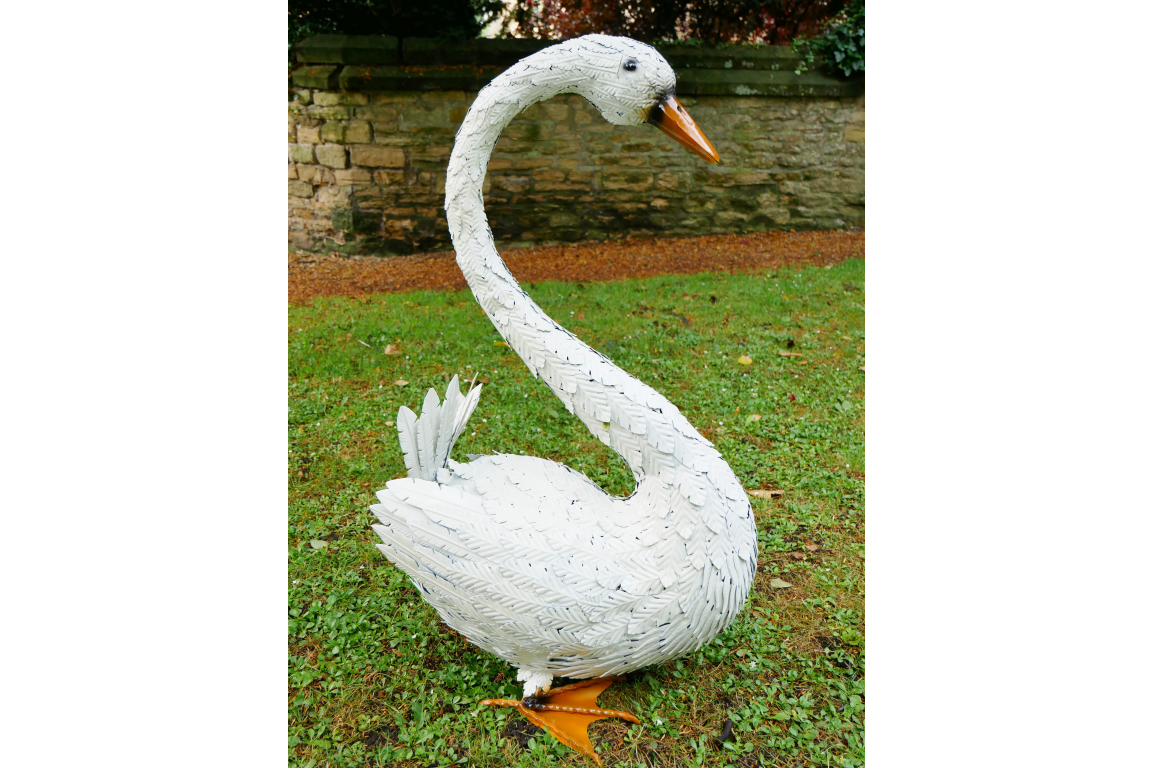 Large Metal Swan Sculpture with white body orange webbed feet and orange beak