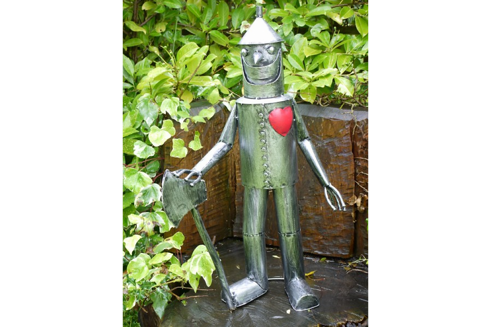 A metal tin man garden ornament with heart on its chest