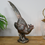 Thumbnail: A decorative metallic pheasant sculpture with intricate feathers