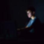 Close-up view of a concerned parent looking at a computer screen
