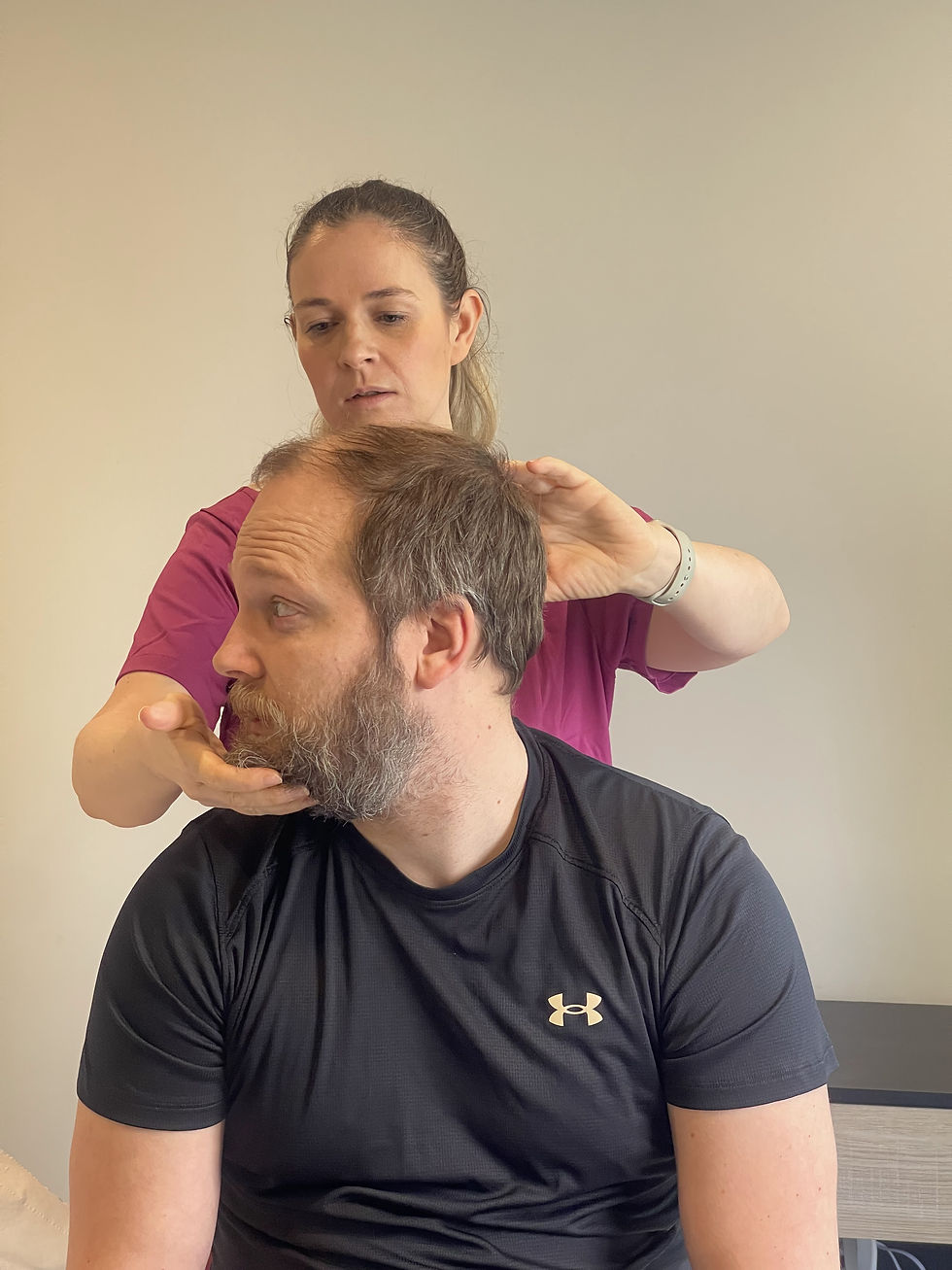 Close-up view of physiotherapist demonstrating an exercise to a patient
