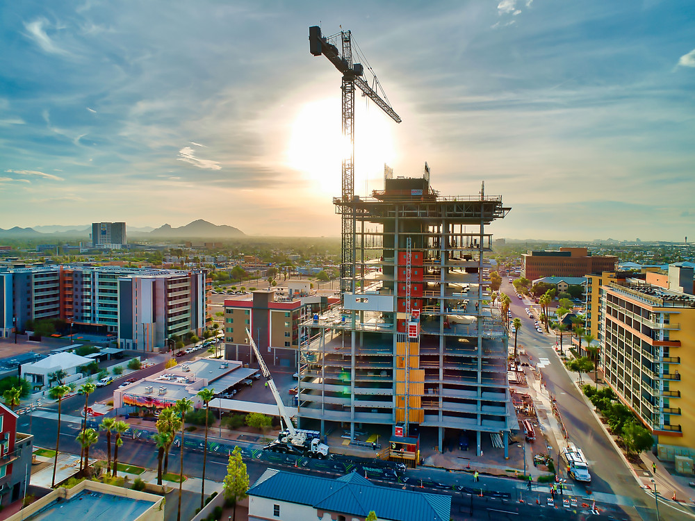 extreme aerial production drone image of building construction with crane