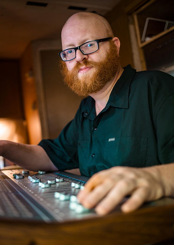David Adam hard at work mixing at his Mixing Console