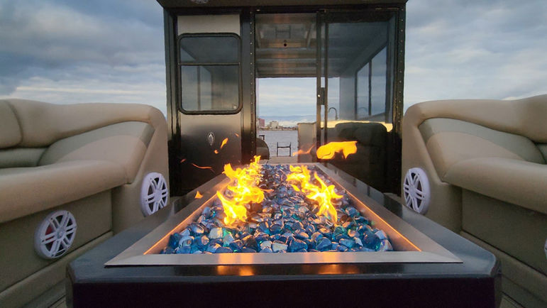 Luxury boat with a fire pit and cozy seating on the water