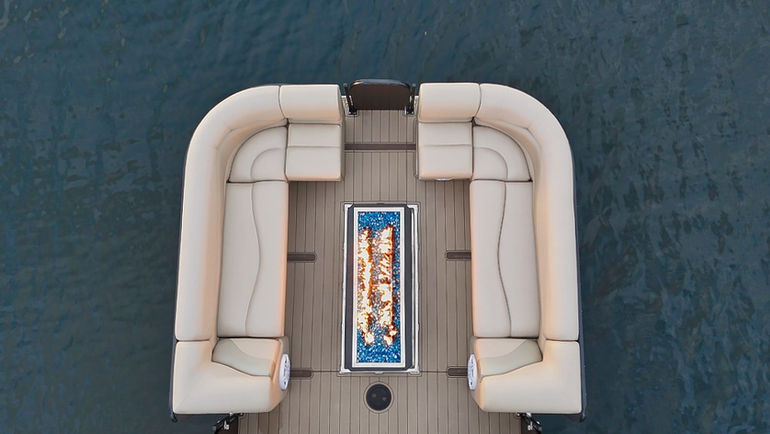 Overhead view of a luxury boat with seating and a fire pit.