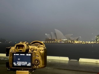 Camera on tripod overlooking the Sydney Opera House