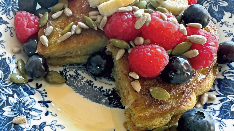 Banana oat pancakes topped with berries, banana slices, and crunchy seeds for some added nutrition