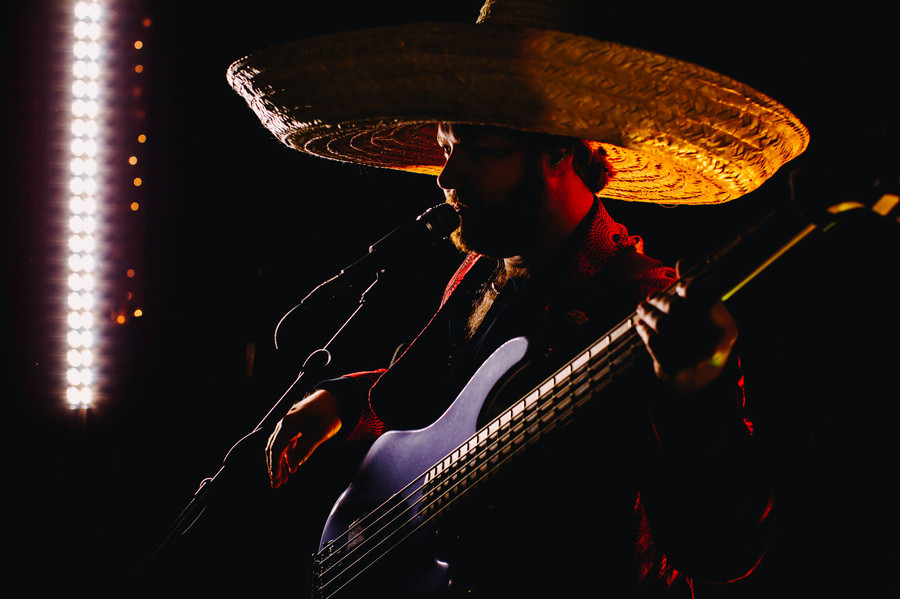 Manuel Dingo playing the bass and singing for wedding crowd. 