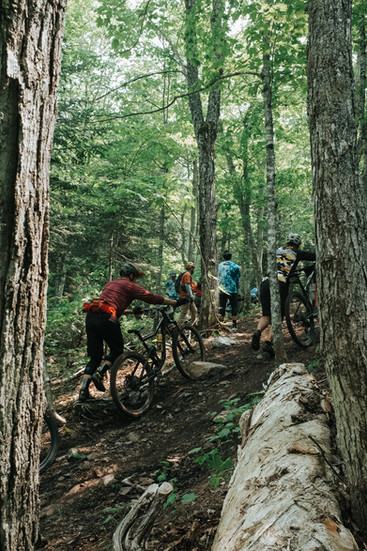 Group of mountain bikers biking uphill, climbing hill in copper harbor