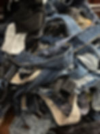 Pile of reclaimed denim fabric for upcycling into fashion handbags