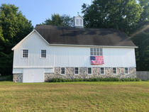 White barn with American flag