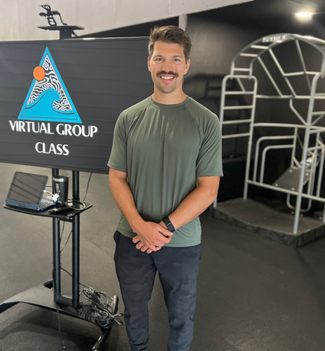 Man teaching an online group fitness class at a gym