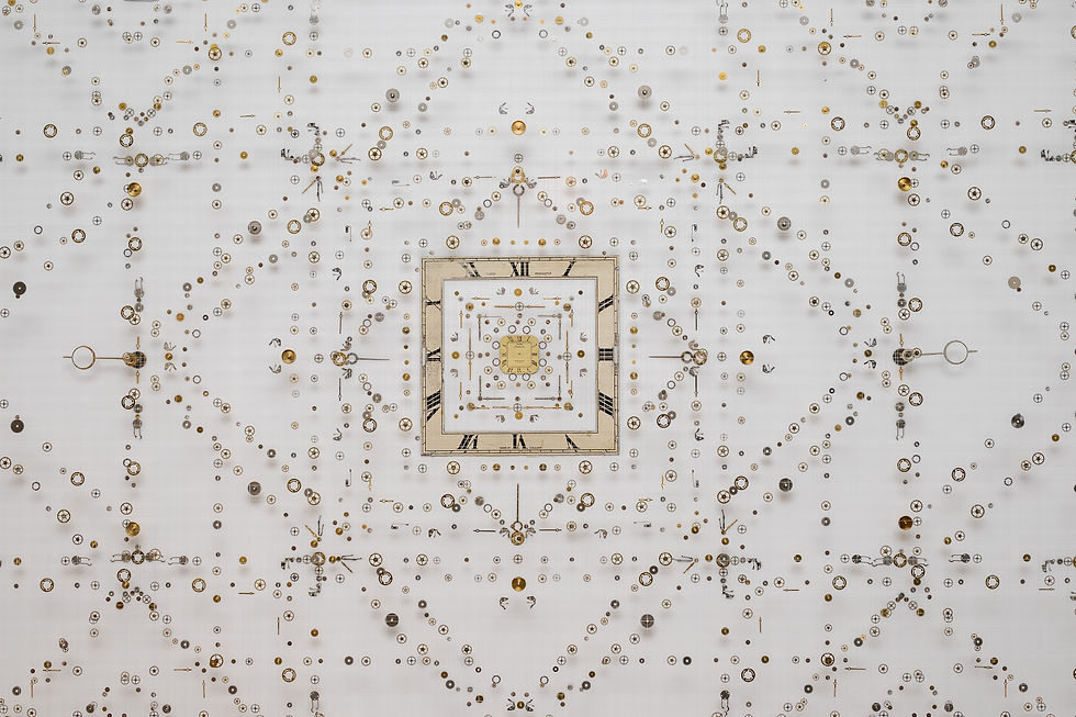 A geometric artwork by Anna Masters created using watch and clock parts
