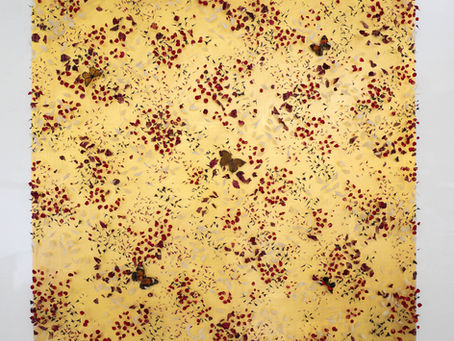 A mixed media artwork by Anna Masters featuring dried petals and butterflies against a gold background
