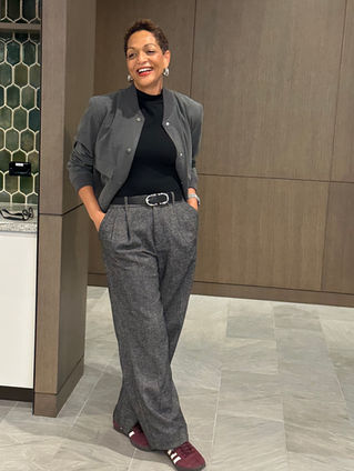 Stylish woman in grey suit layered with black turtleneck