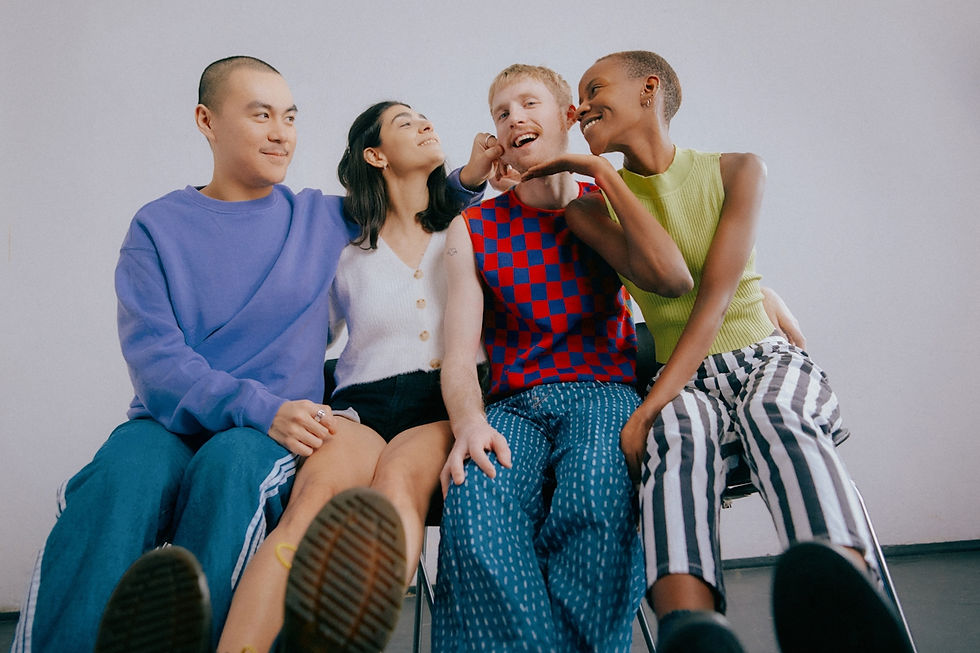 four people sitting together in vibrant clothing