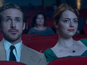 Ryan Gosling and Emma Stone sitting in a theater in La La Land