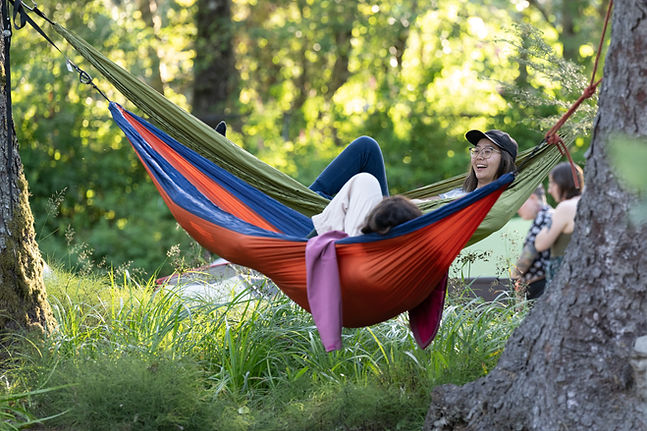 Two people relaxing in hammocks in the sun