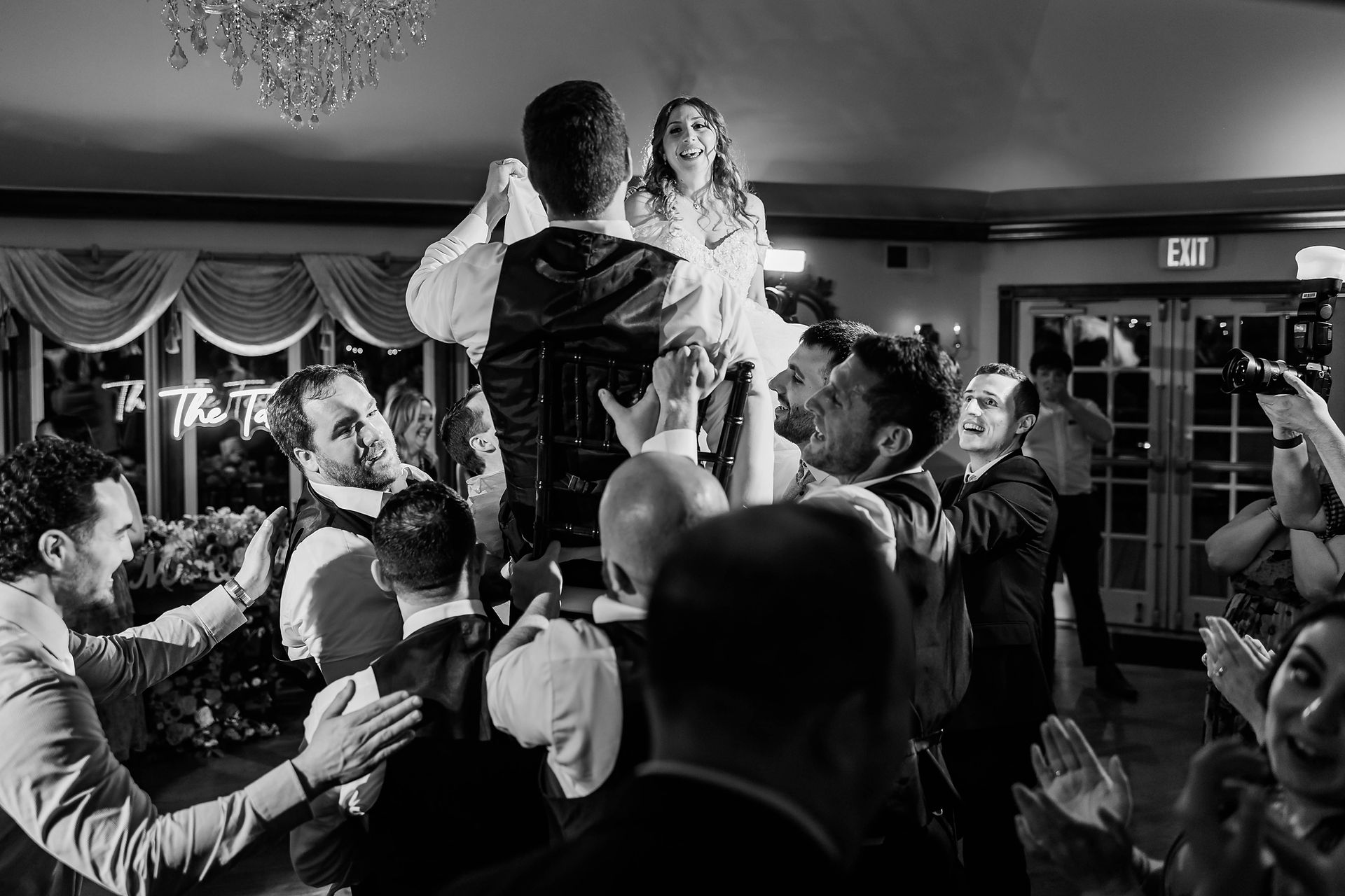 Elegant wedding reception setup at The Farmhouse in Delaware featuring white linens, gold chairs, and high-ceiling architecture for Jessie and Austin's May 2025 celebration.
