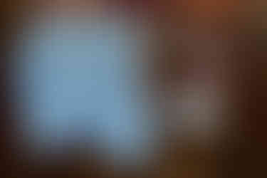 Custom bridal jean jacket draped over a sweetheart table chair in the main hall at The Farmhouse Delaware.