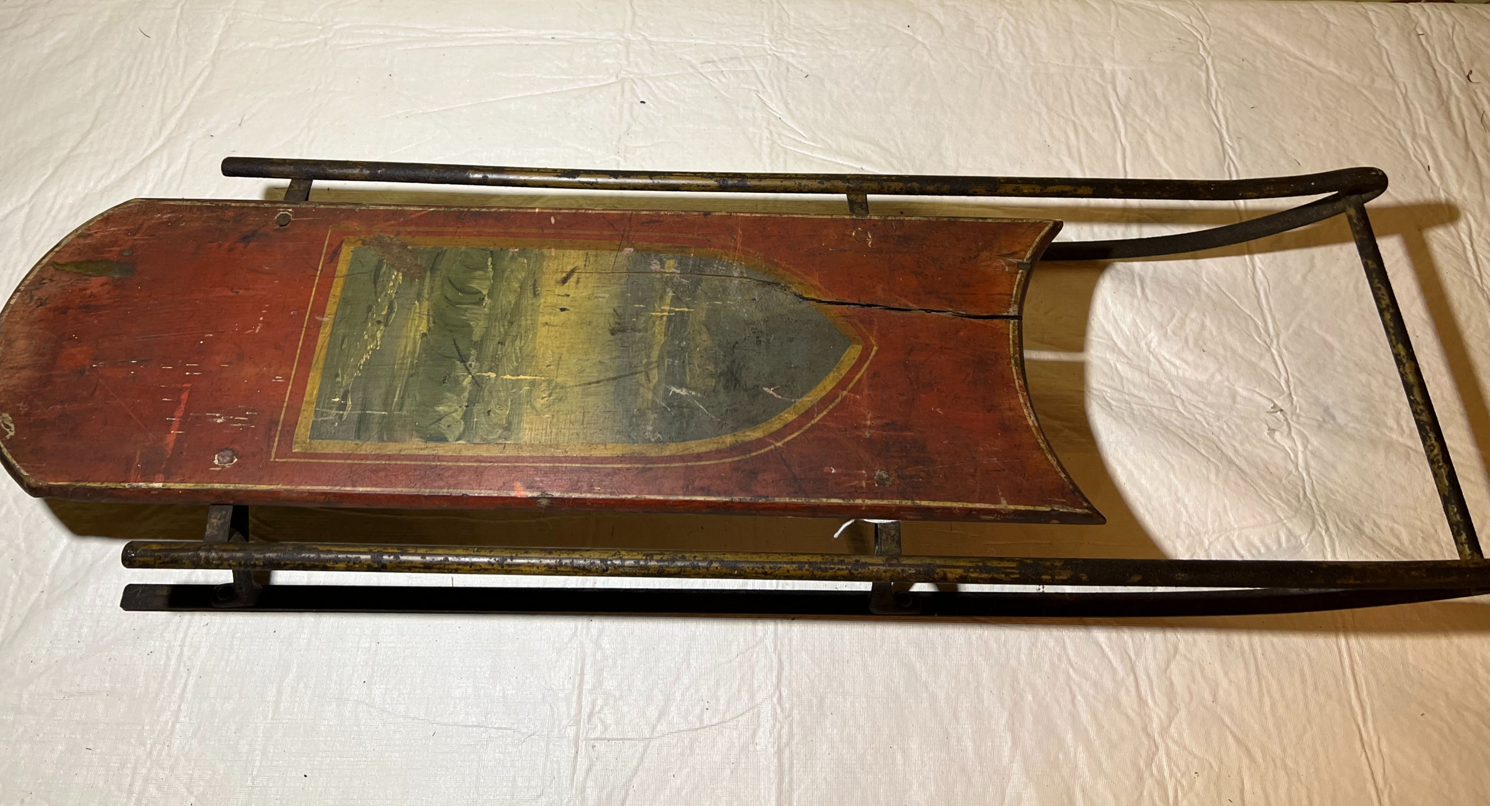 #46 Early sled with ocean picture, red paint.