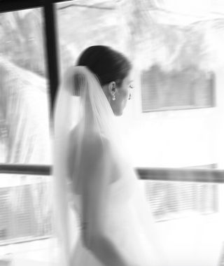 Black and white bridal portrait by a window