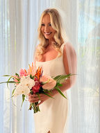 Bride with natural soft glam makeup holding a tropical wedding bouquet in Holbox