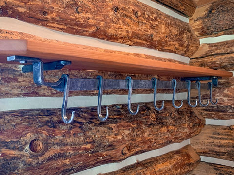 Hand forged hooks in a log cabin