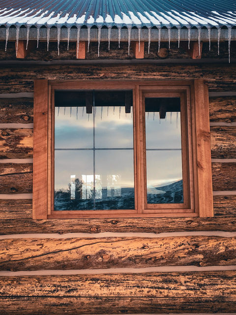 Hand built window in a log cabin