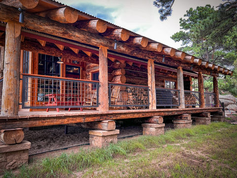 Log cabin covered porch with exposed rafters