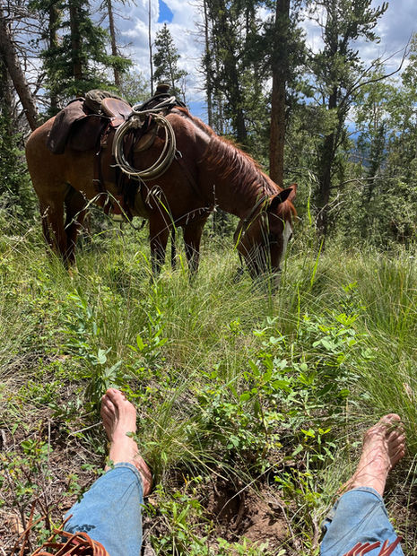 Joe Kuckla reclining with horse
