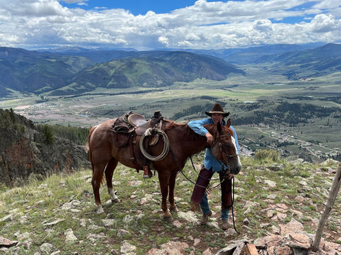 Joe Kuckla and horse overlooking mountain valley