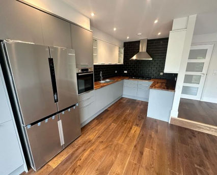 New kitchen with large silver fridge freezer and wooden flooring