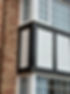 Close-up of white cladding at side of house