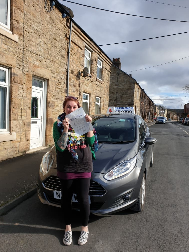 Happy young female holding pass certificate over face
