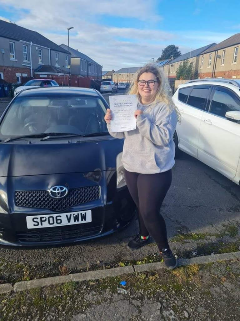Happy young woman with pass certificate