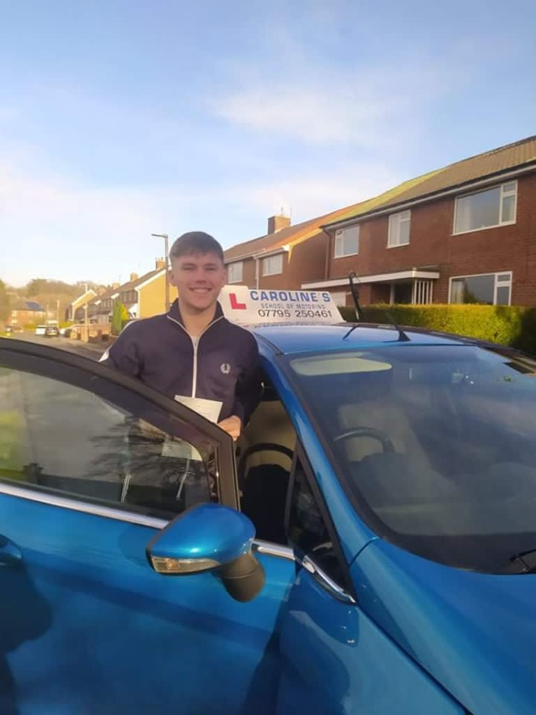 Smiling man behind driver's side door