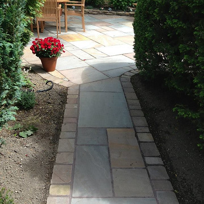 Complete paved pathway with bushes and seating area